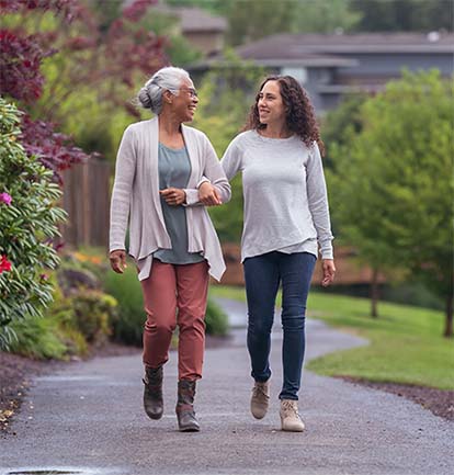 Older adult walking outside with loved one | National Lutheran Communities & Services