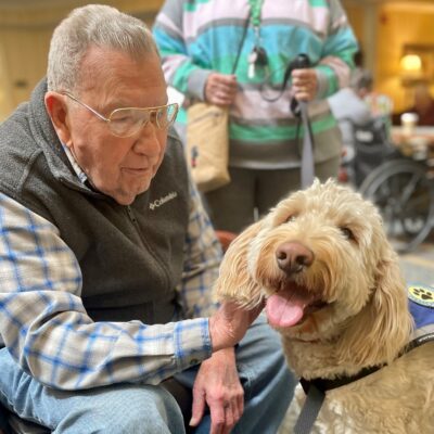 Resident with therapy dog | National Lutheran Communities & Services